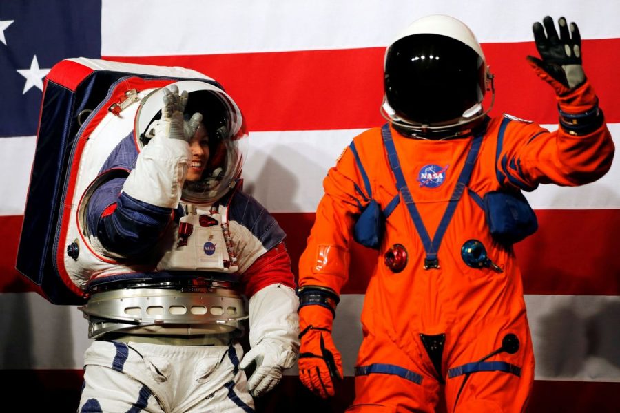 Advanced Space Suit Engineer at NASA Kristine Davis wears the xEMU prototype space suit next to lead engineer Dustin Gohmert wearing the Orion crew survival spacesuit prototype for the next astronaut to the moon by 2024, during a presentation at NASA headquarters in Washington, U.S., October 15, 2019. REUTERS/Carlos Jasso